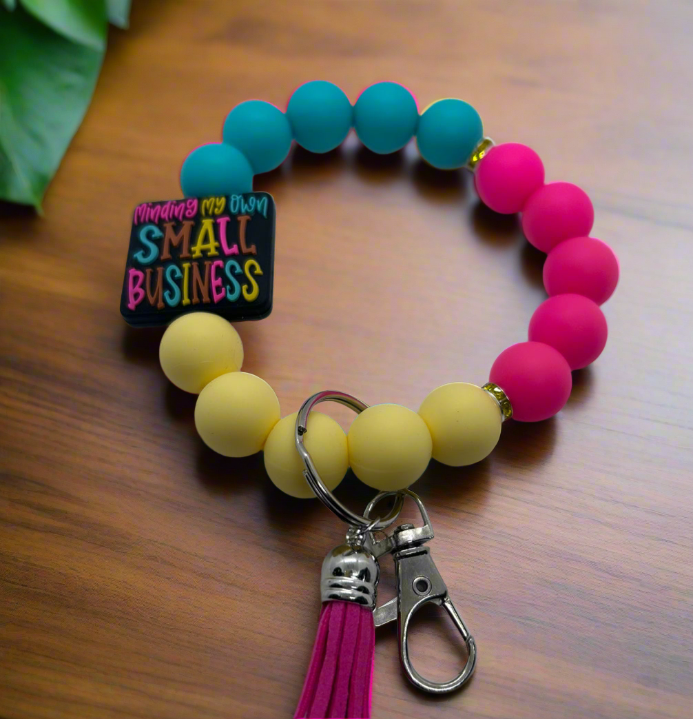Blue, pink, and yellow silicone beaded wristlet keychain