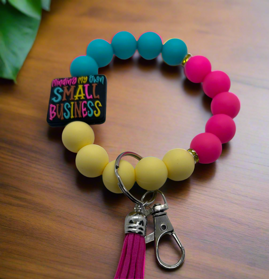 Blue, pink, and yellow silicone beaded wristlet keychain 