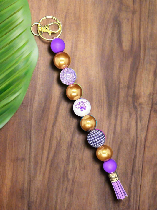 western carolina university beaded purple and gold keychain with purple tassle